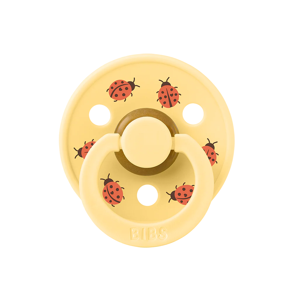 À l'unité : Suce Bibs (ronde) studio  jaune avec coccinelles